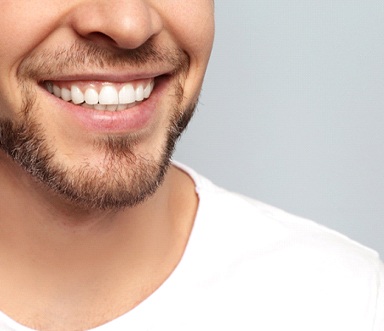 man smiling who understand the cost of cosmetic dentistry in Burlington