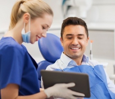 Dental team member and patient discussing emergency dentistry frequently asked questions