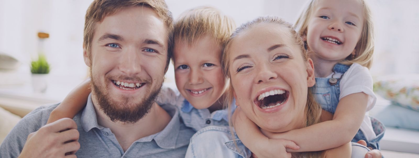 Family of four smiling together