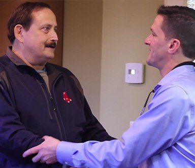 Dentist shaking hands with dental patient