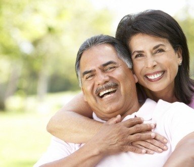 Couple sharing flawless smile after all on four dental implants