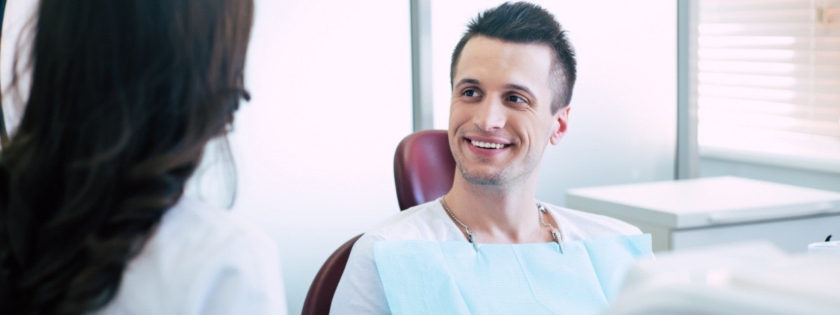 Man smiling during dental checkup and teeth cleaning visit