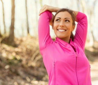 Woman sharing healthy smile thanks to dental checkups and teeth cleanings