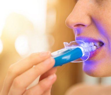 Dental patient receiving zoom in office teeth whitening