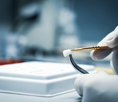 Dental lab technician crafting a dental crown