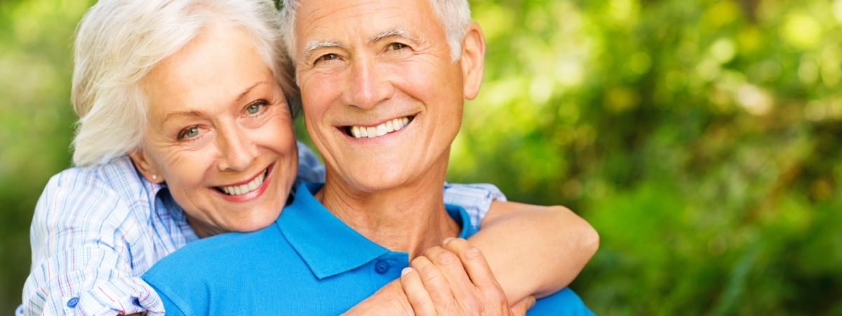 Older couple enjoying the benefits of dentures and partials