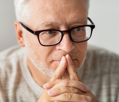 Man discussing dentures frequently asked questions with dentist