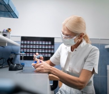 Dental technician crafting a denture