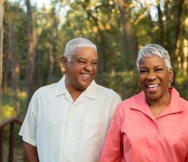 Man and woman with dentures smiling together