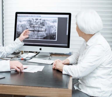 Dentist and patient discussing the cost of dentures