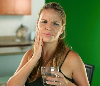 Woman in pain before tooth extraction