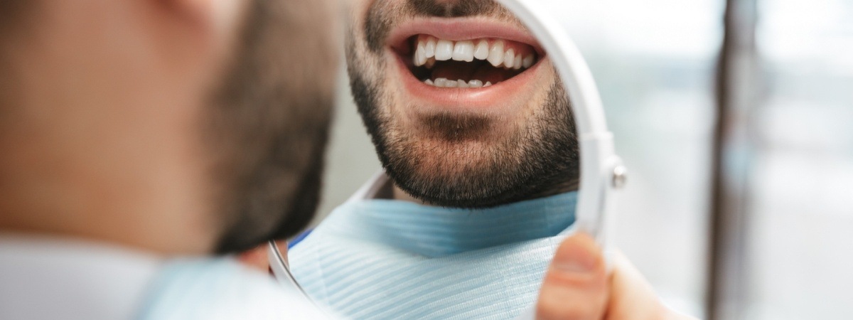 Patient looking at smile after tooth colored filling restoration