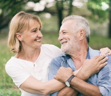 Older couple with dental implant retained dentures