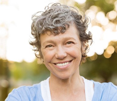 patient smiling after getting dental implants