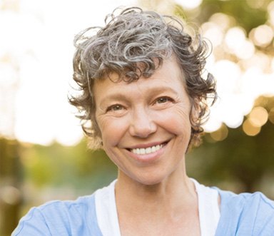 patient smiling after getting dental implants 