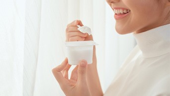 closeup of patient eating yogurt  