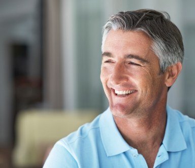 Man enjoying the benefits of dental implant retained mult teeth replacement