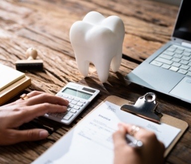 Patient calculating the cost of dental implants