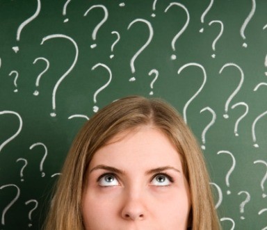 Woman surrounded by question marks