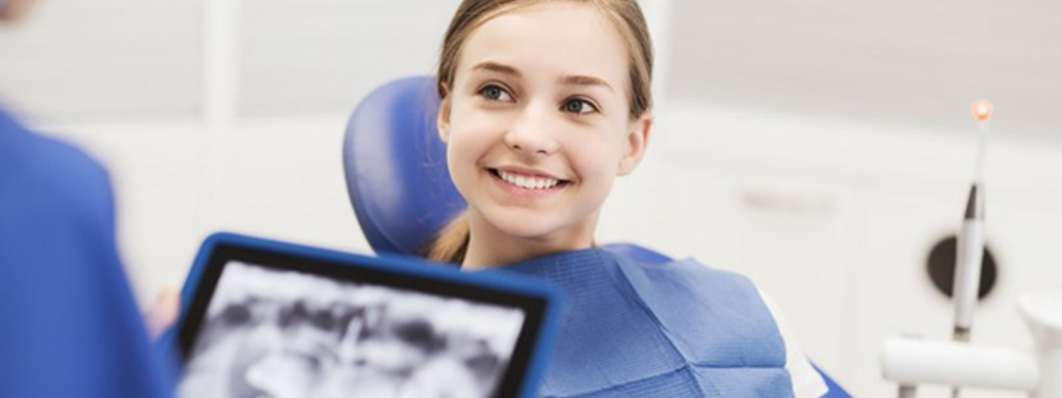 Young girl smiling while receiving pediatric dentistry in Burlington 