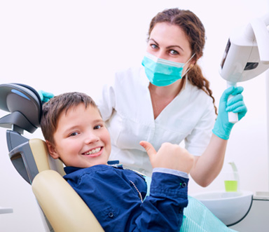 Boy smiling and giving thumbs up after proper screening 
