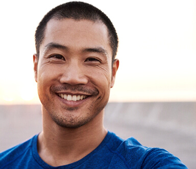 man smiling while standing outside