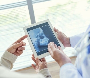 Dentists looking at digital x-rays during regular dental checkup