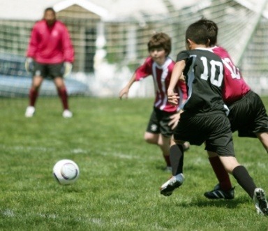 Children playing sports with protective mouthguards