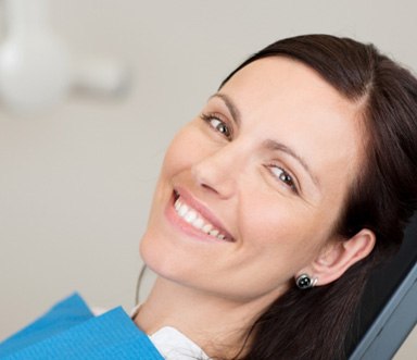Female patient leaning back in chair and smiling