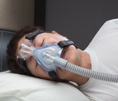 Person sleeping with CPAP mask for sleep apnea