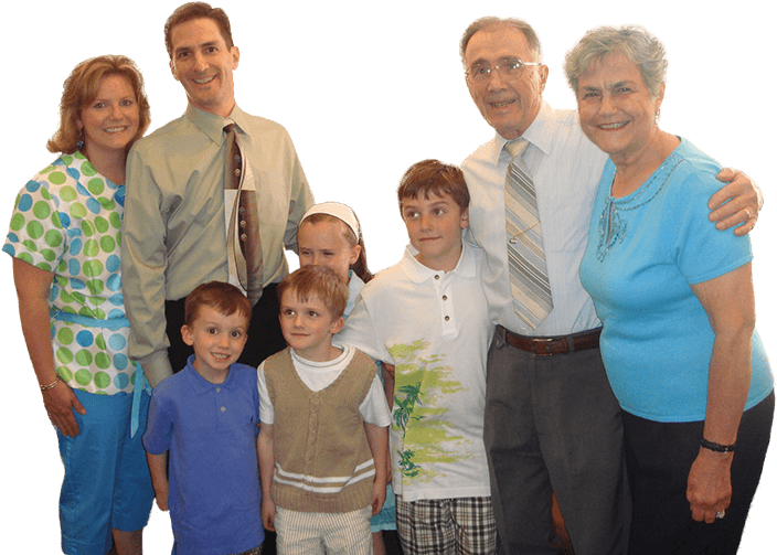 Dr. Kostas and a family smiling