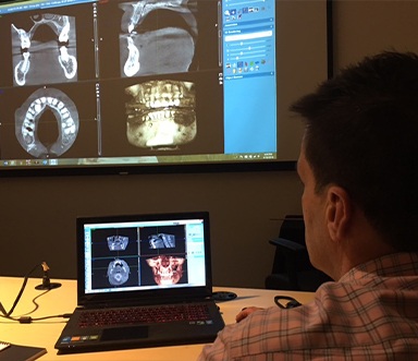 Dentist looking at digital dental x-rays