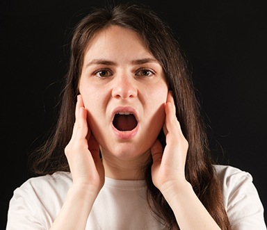 a patient holding her mouth open in pain