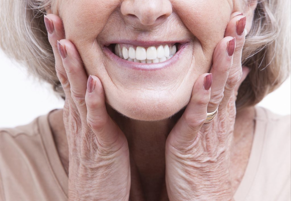 Photo of a woman with dentures smiling