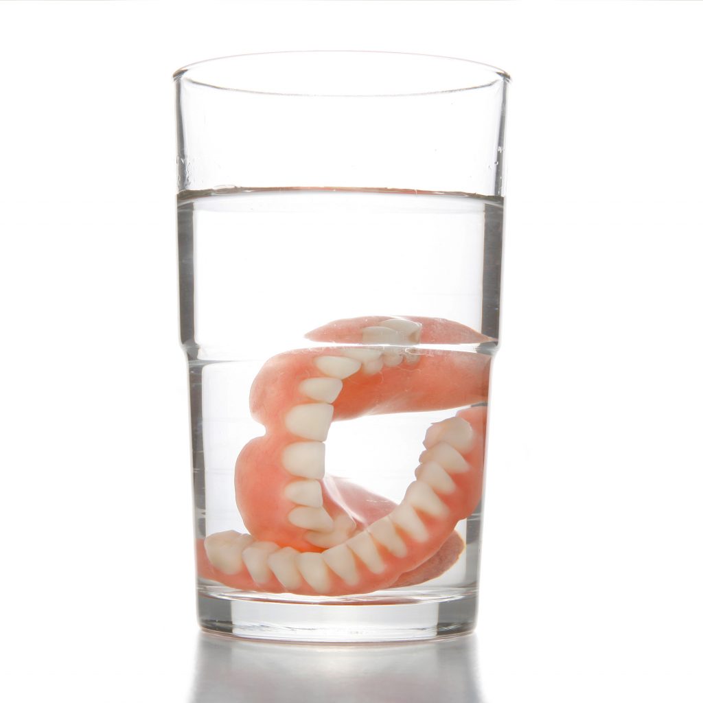 dentures soaking in water