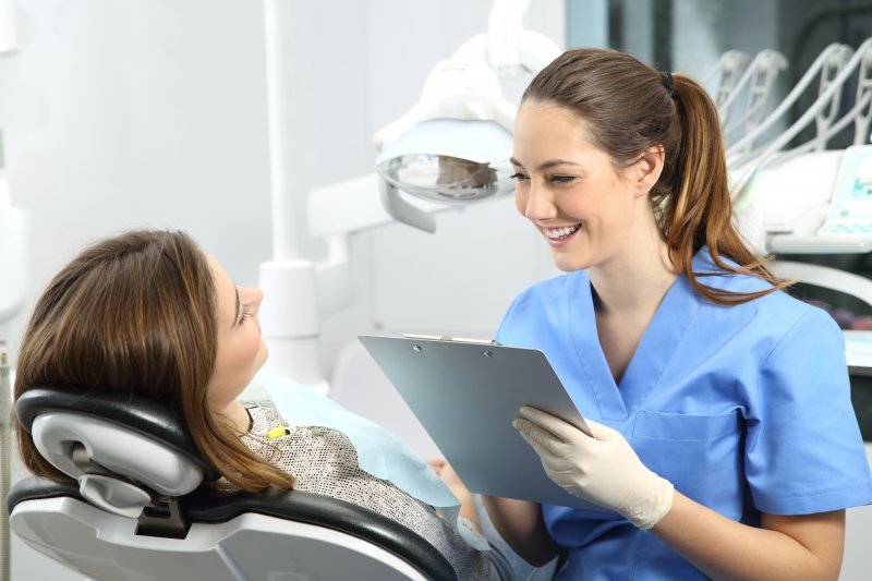 person speaking with cosmetic dentist about gum disease therapy