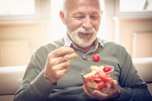 person eating a salad on their couch