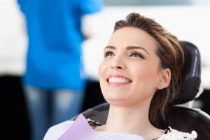 woman smiling about to get a root canal in Burlington 