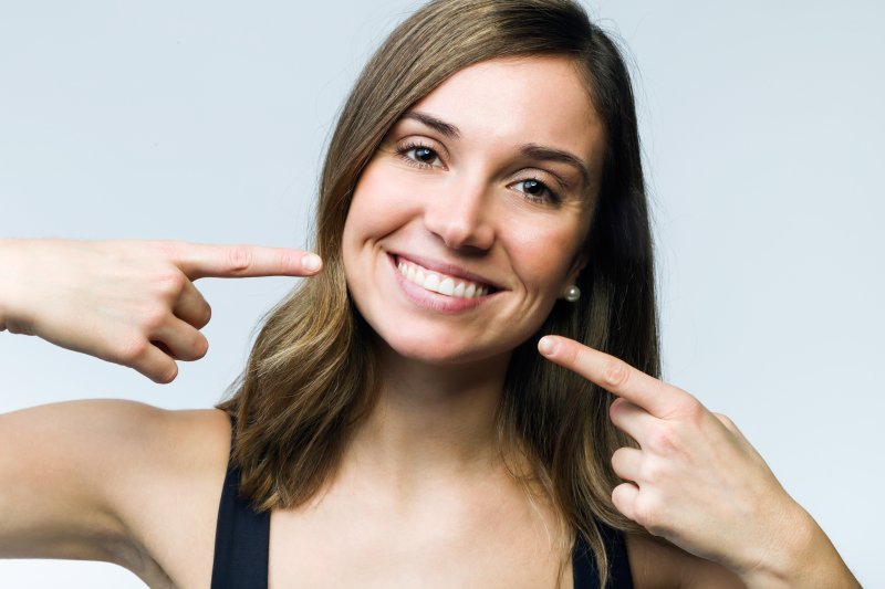 Woman pointing to her teeth