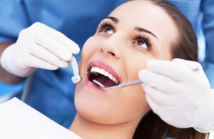 Woman visiting the dentist burlington loves to use up her benefits for 2015