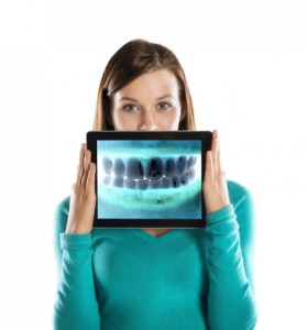 Woman holding digital x-ray at emergency dentistry burlinton trusts from complete dental care